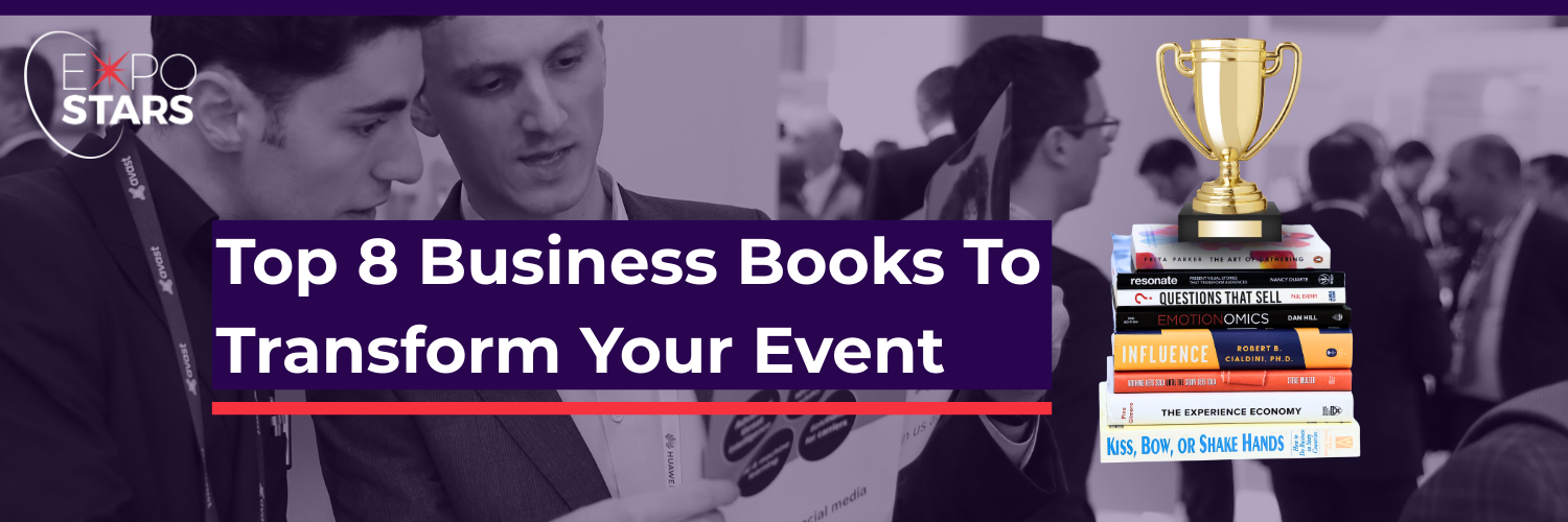 Top 8 Business Books to transform your event. image features two men looking at the a book. Then there is a stack of books with a trophy on top. 